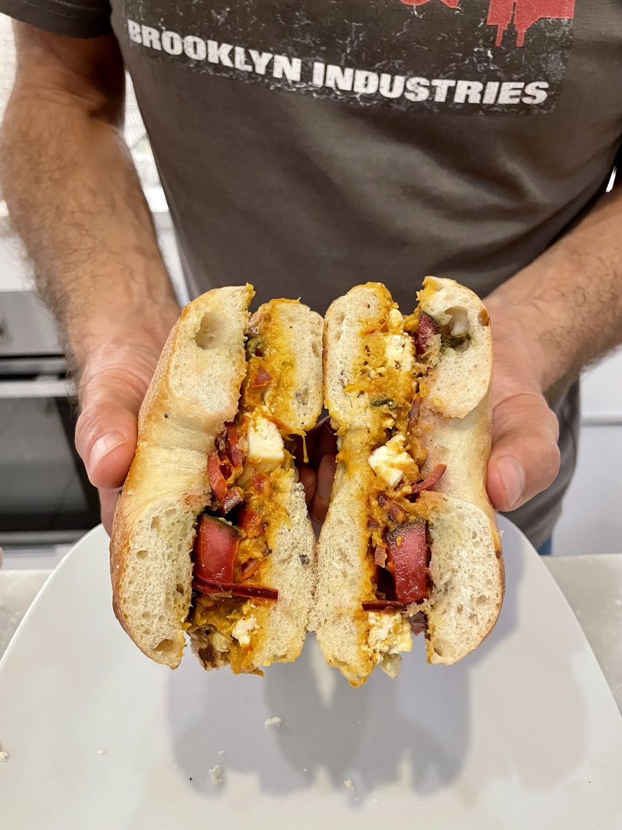 A bagel sandwich held open