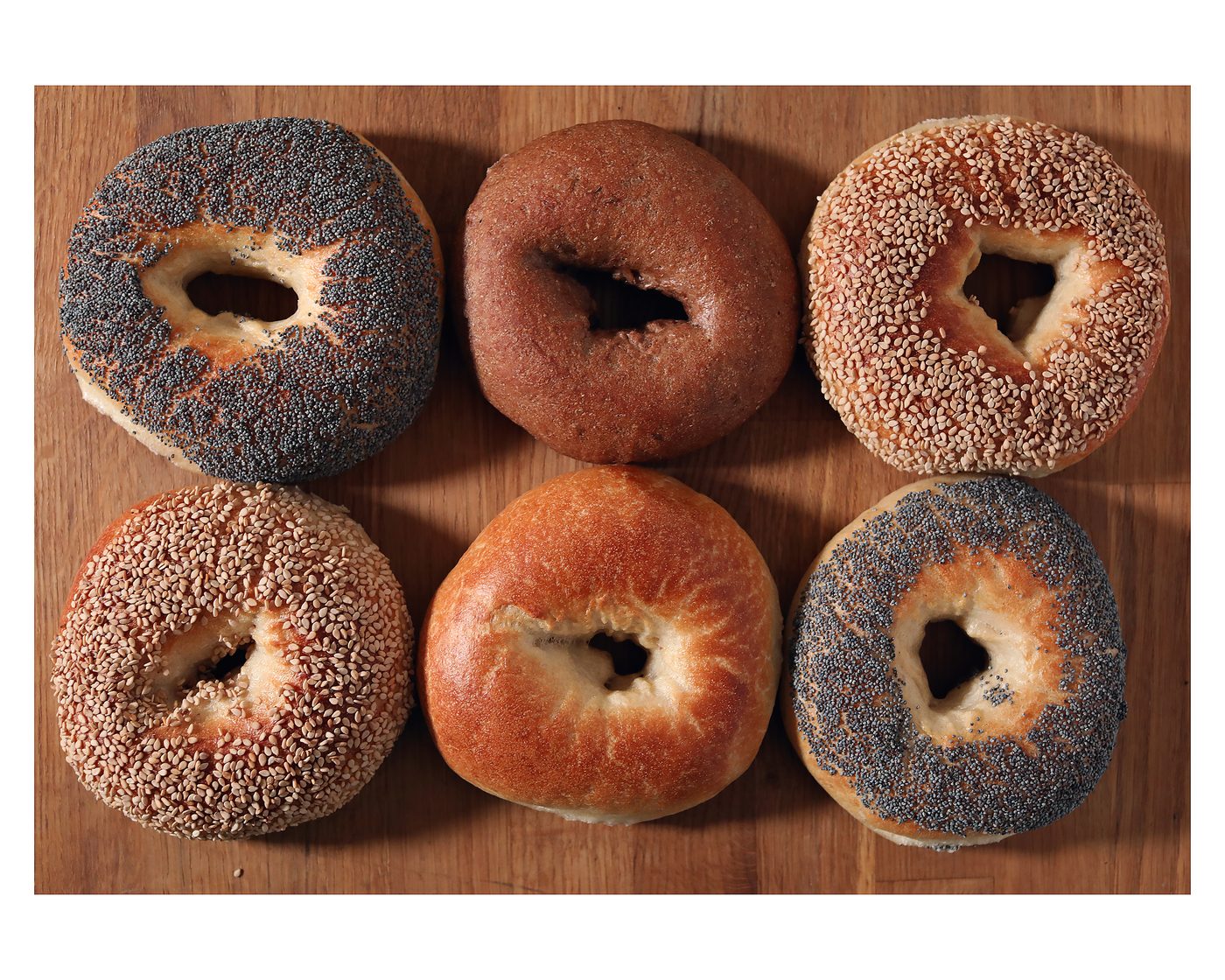 Six bagels on a wooden board